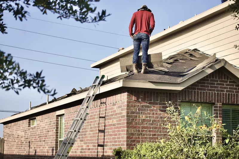 Professional roofer working on a residential roof in Papillion